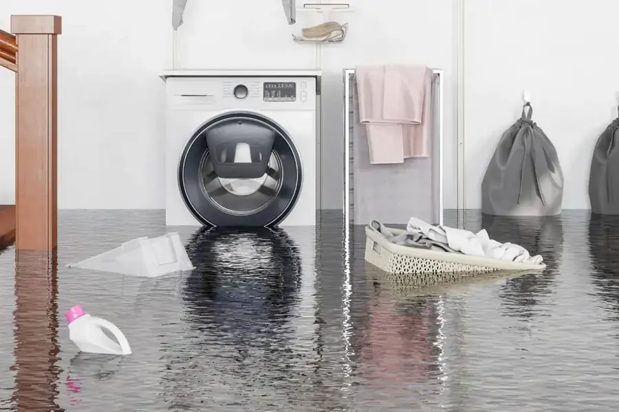 Appliance supply line leak flooding an Enfield, CT laundry room